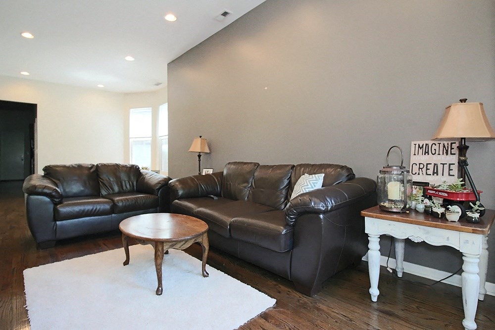 a living room with leather couches and a coffee table