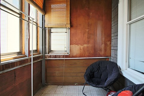 a room with a chair and a window in it