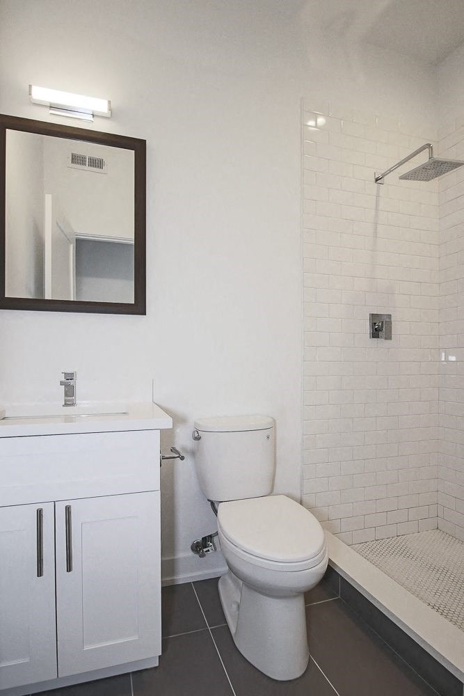 a bathroom with a toilet and a sink and a shower