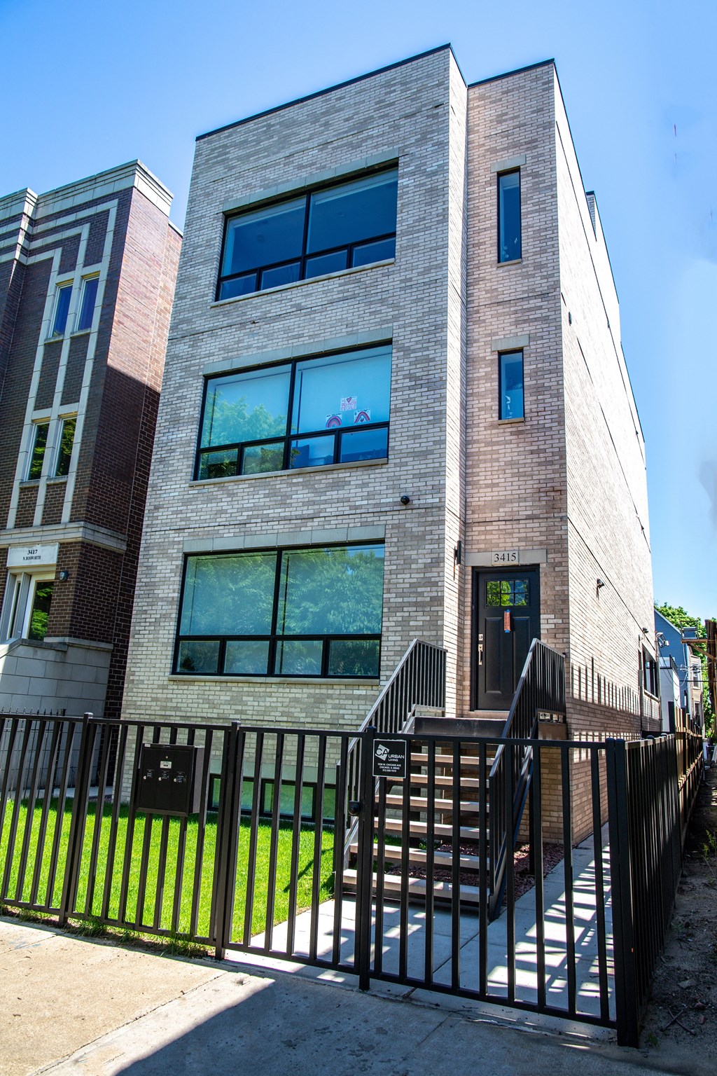 a building with a stairway and a fence in front of it