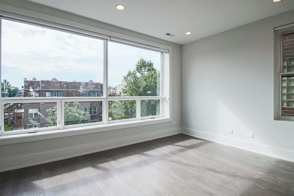 an empty living room with a large window