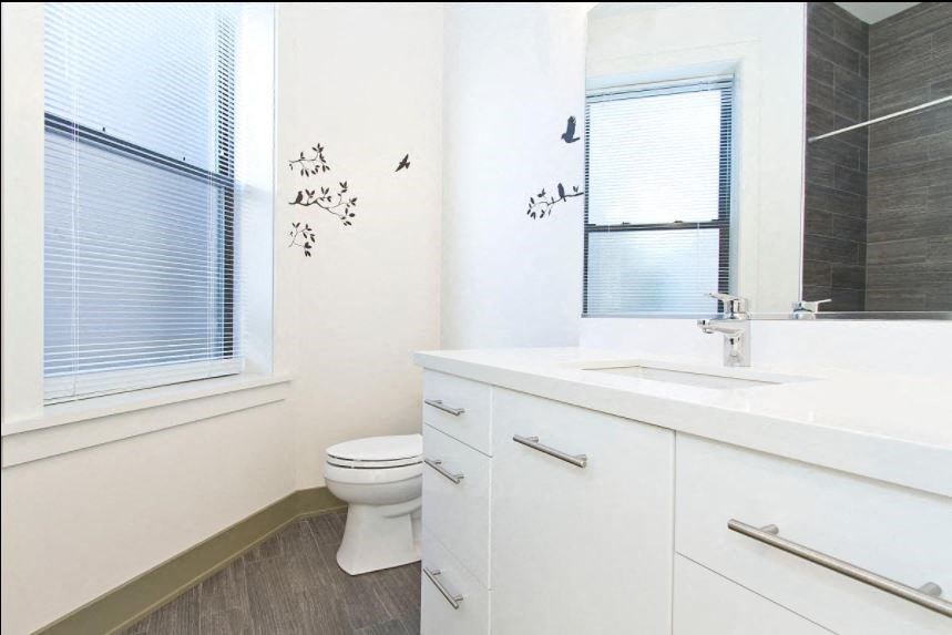 a bathroom with a toilet and a sink and a mirror