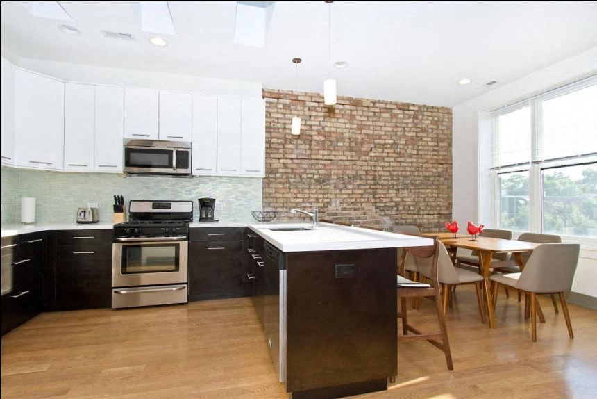 a kitchen with an island and a table with chairs
