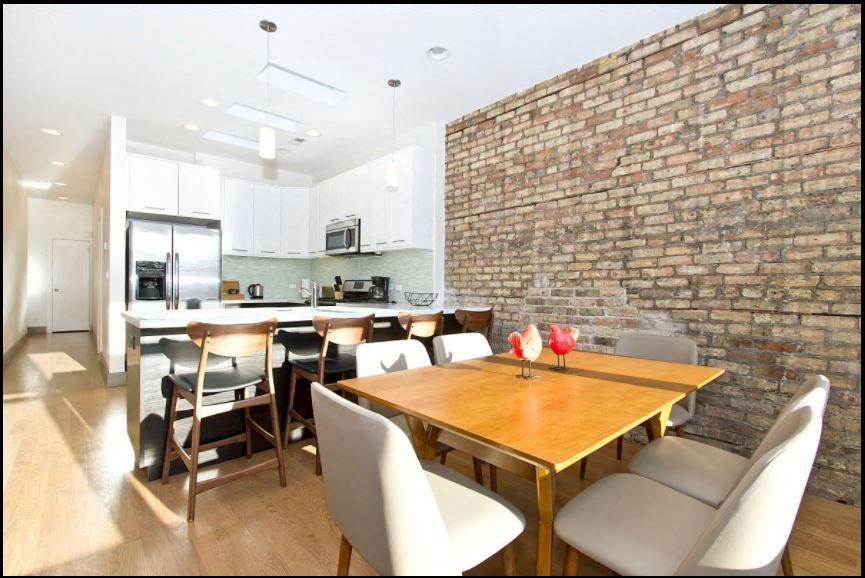 a dining room and kitchen with a table and chairs