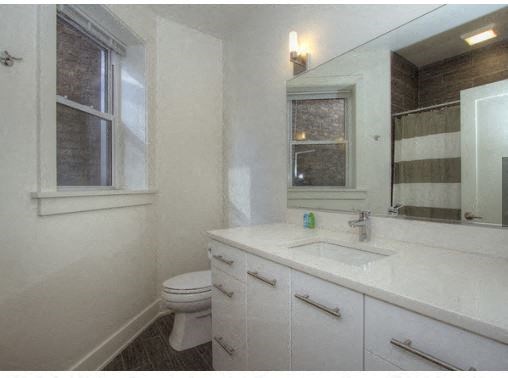 a bathroom with a sink toilet and a mirror