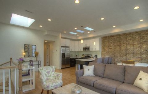 a living room with a couch and a kitchen