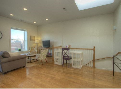a living room with a couch and a table with chairs