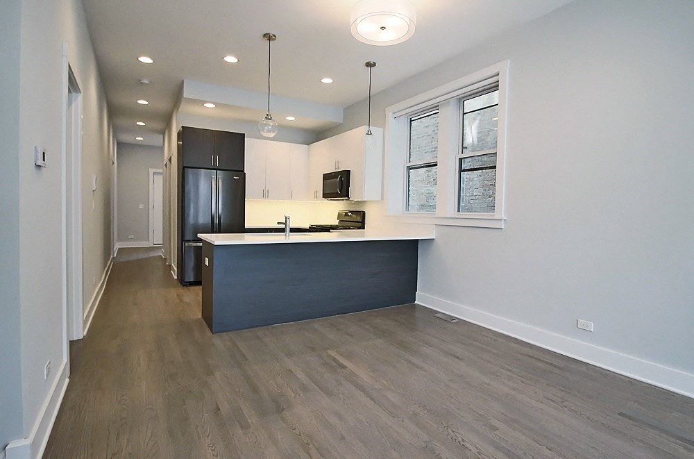 an empty kitchen with a counter top in a house