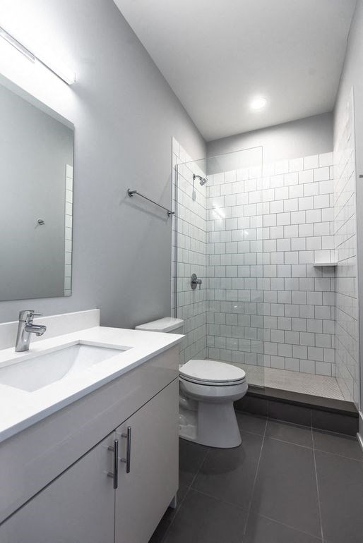 a white bathroom with a toilet and a sink