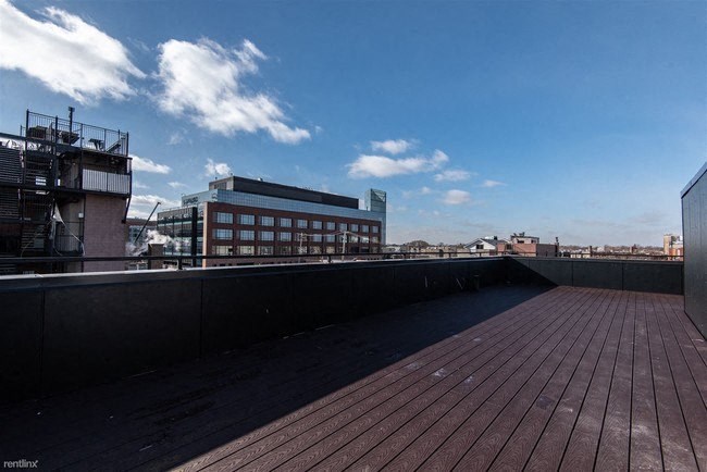 the roof of a building with a city in the background