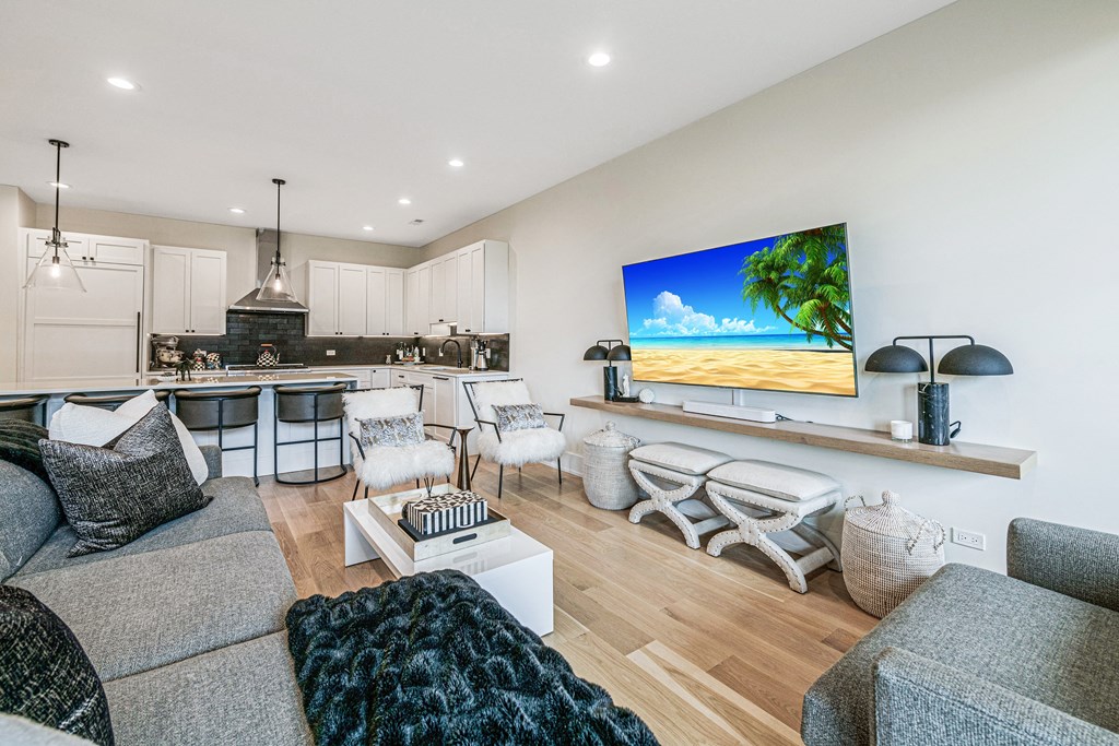 a living room with a kitchen and a couch and a table