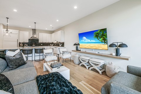 a living room with a kitchen and a couch and a table