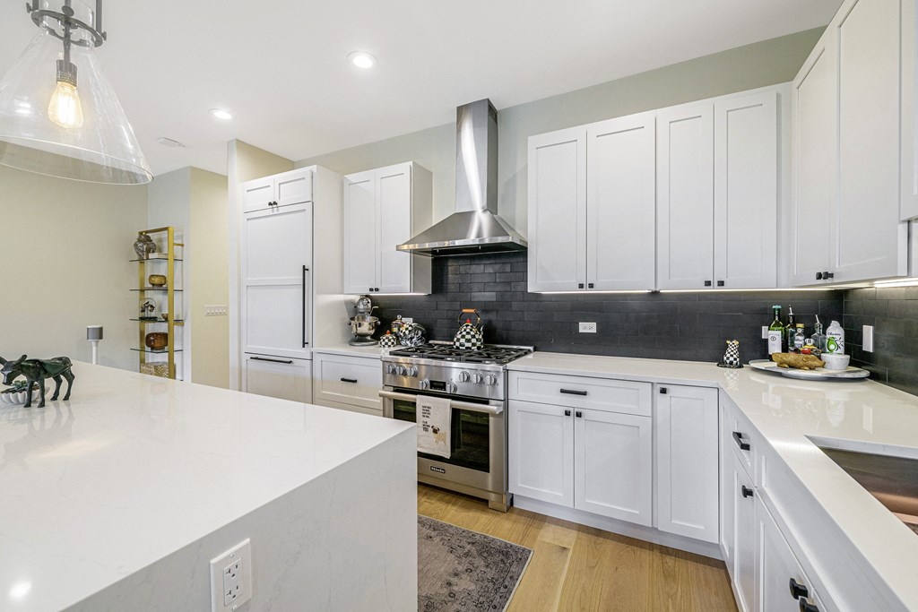 a kitchen with white cabinets and a white counter top