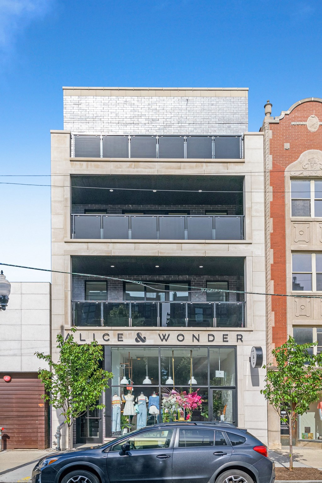 a black car parked in front of a building