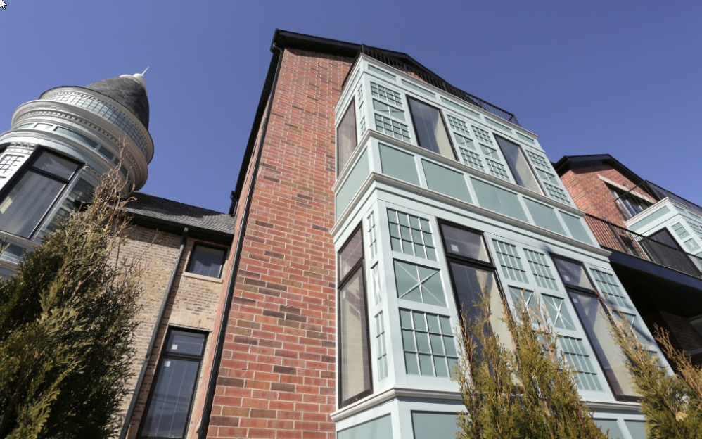 the facade of a brick building with a water tower