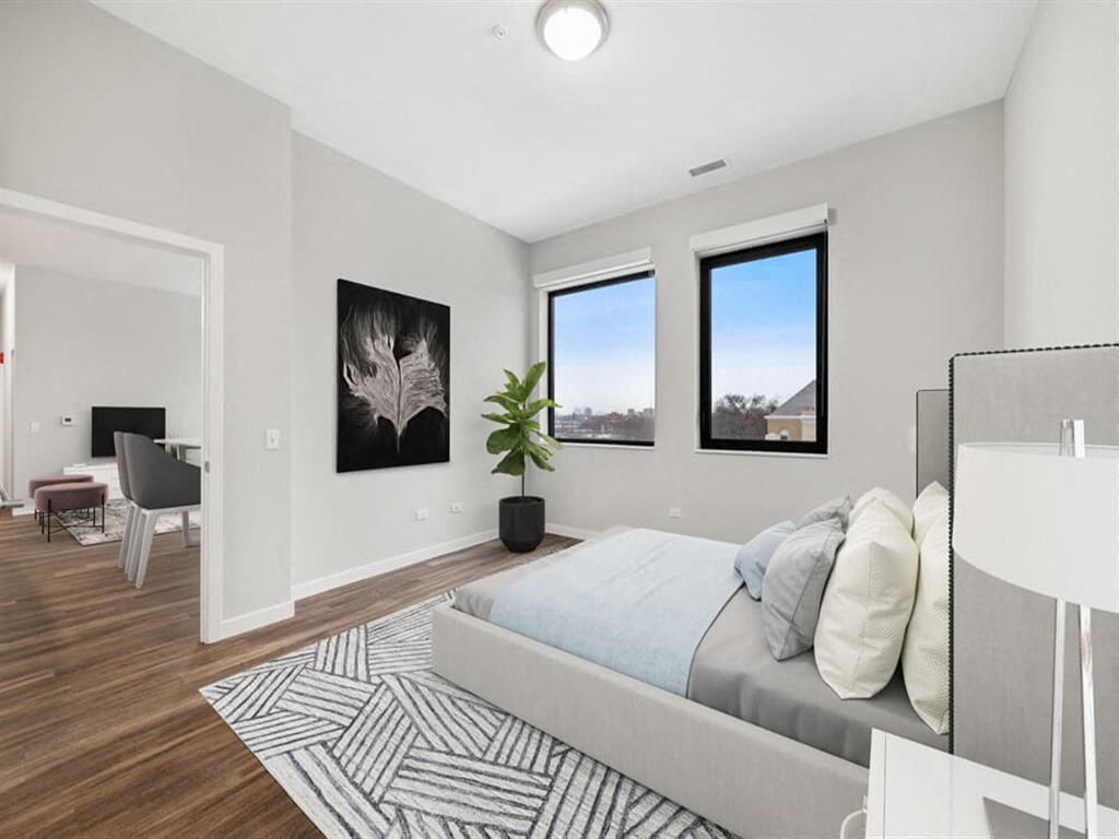 a bedroom with a bed and three windows