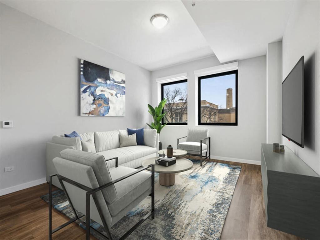 an apartment living room with a couch and a tv