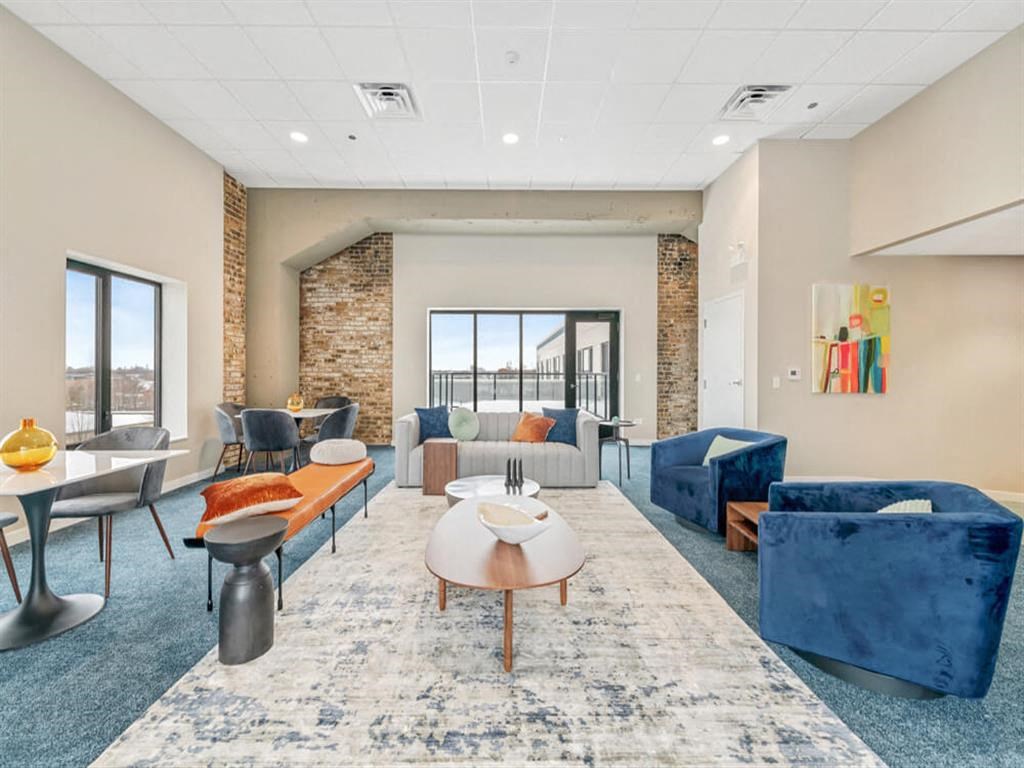 a living room with couches and chairs and a table