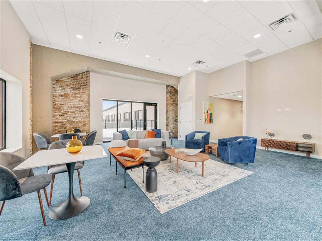 a living room with couches tables and chairs and a large window