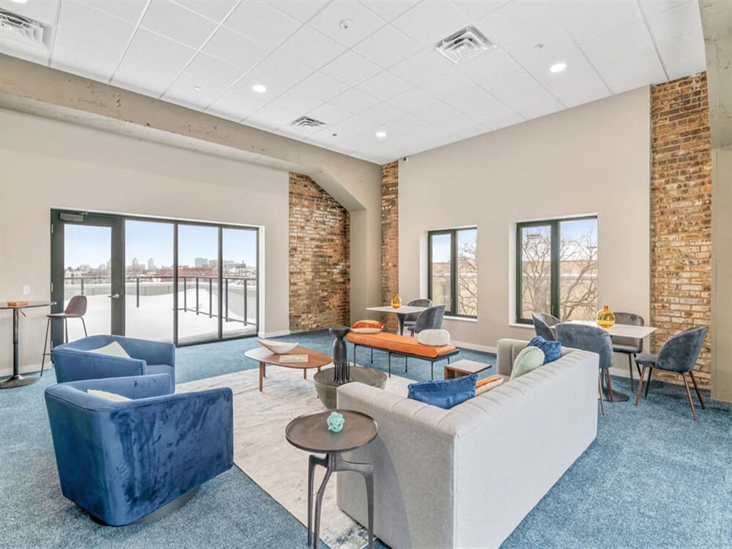 a living room with a couch and chairs in front of a window