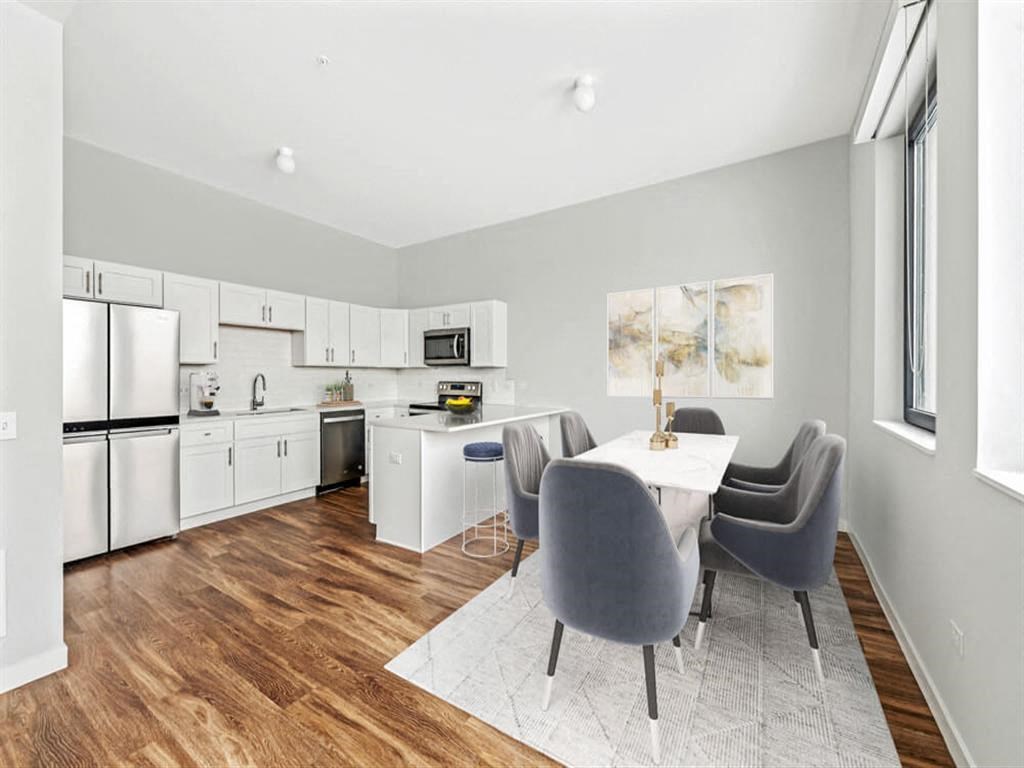 a kitchen and dining room with a table and chairs