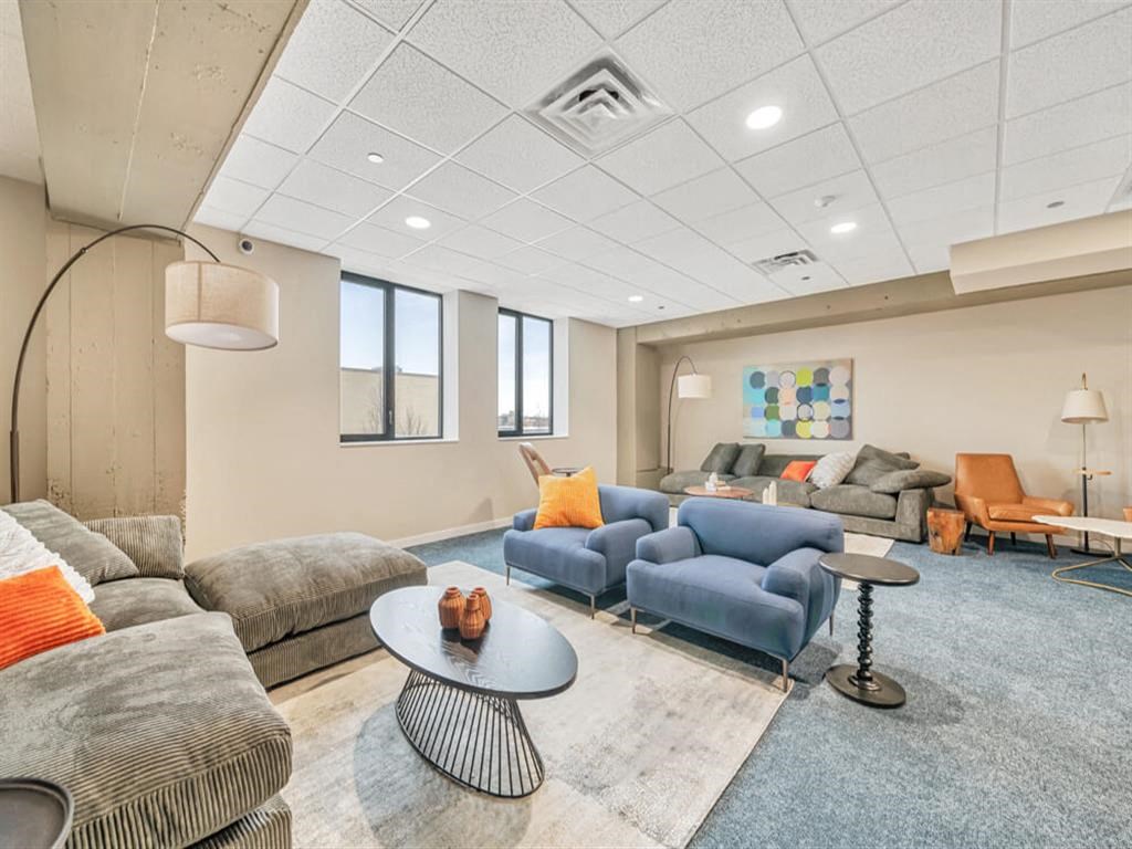 a living room with couches and chairs and a table