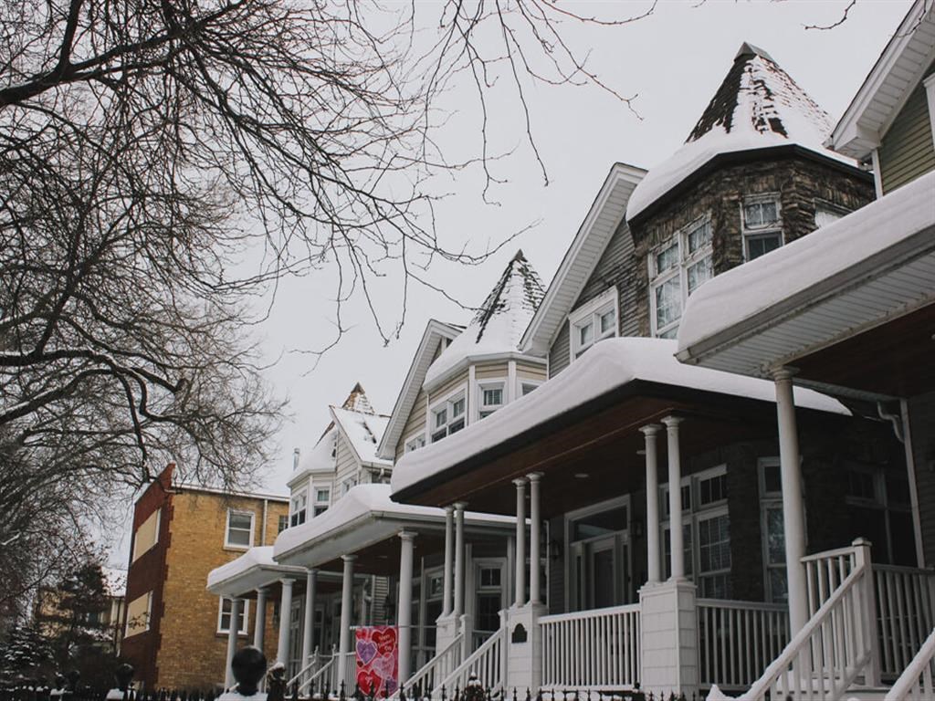 a row of houses covered in snow
