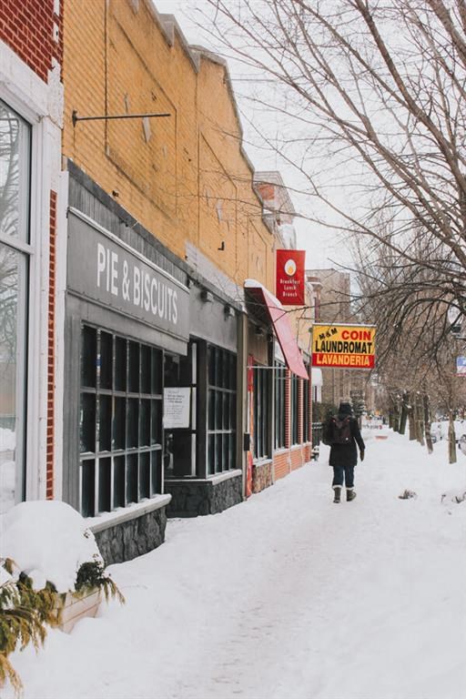 a person walking down a snow covered street