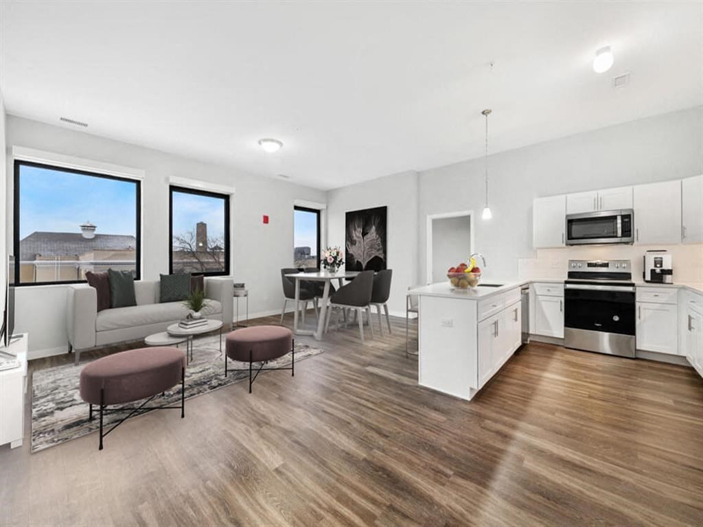 a living room with a kitchen and a table