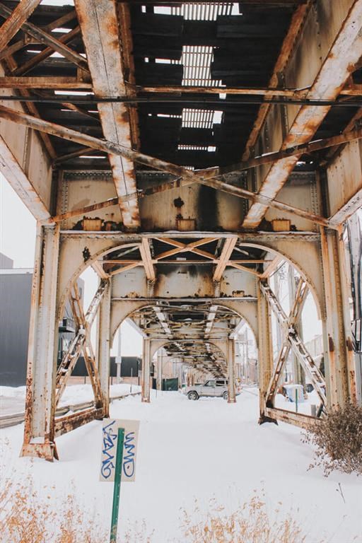 a view of the underside of a bridge in the snow