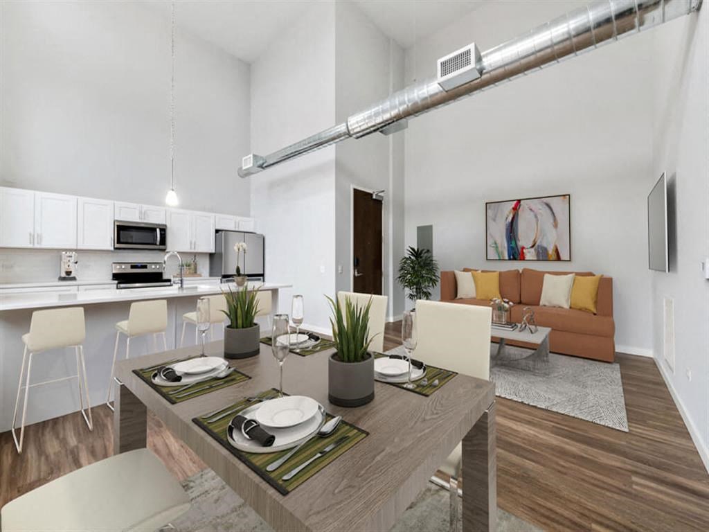 a living room and dining room with a table and chairs