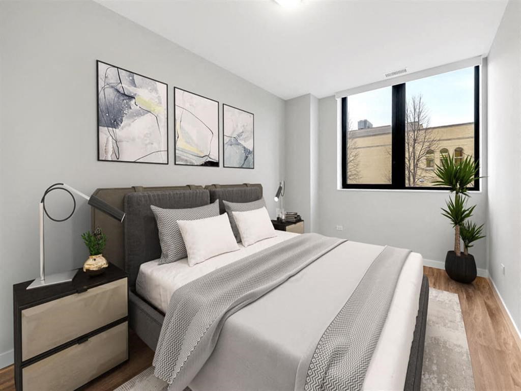 a bedroom with a large bed and a window