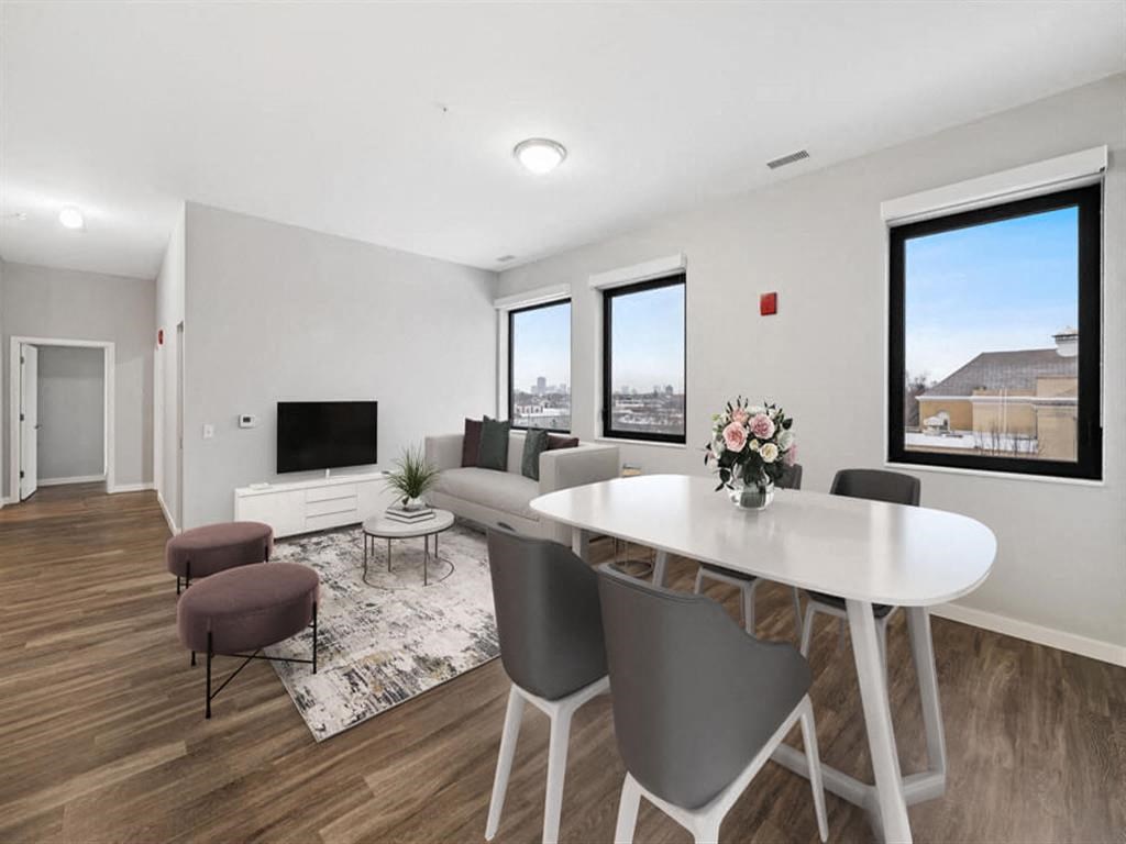 an open living room and dining room with a table and chairs