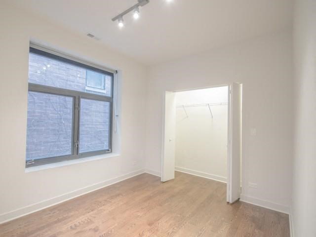 an empty room with a large window and a door