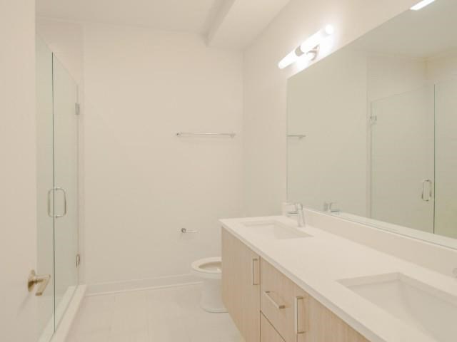 a bathroom with a toilet and a sink and a mirror