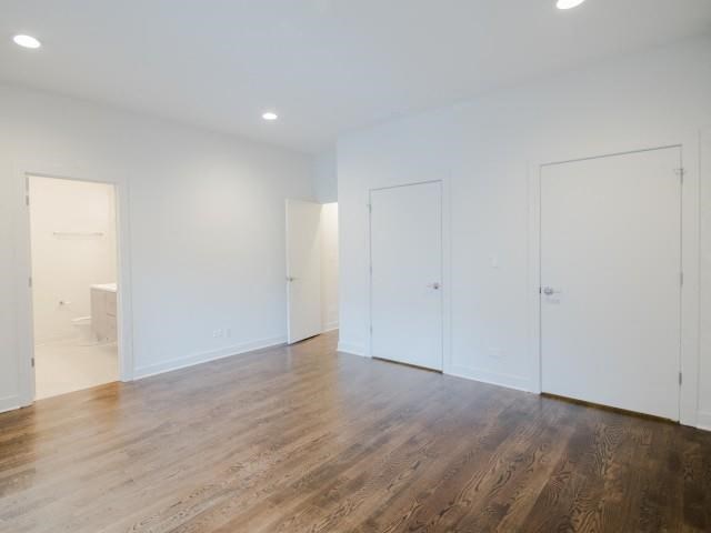 an empty living room with white walls and wood floors