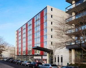 a large building with red stripes on the side of it