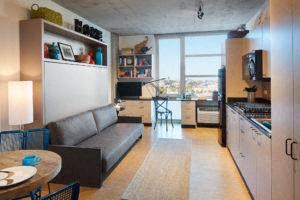 a living room with a couch and a kitchen