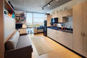 a large kitchen and living room with a couch