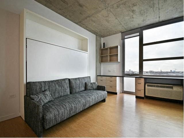 a living room with a couch and a window