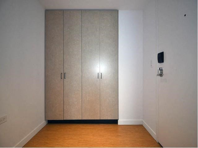 a room with two closet doors and a wood floor