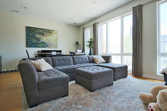 a living room with a large gray couch and a rug
