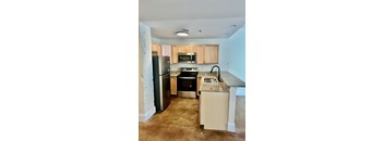 an empty kitchen with stainless steel appliances and granite counter tops