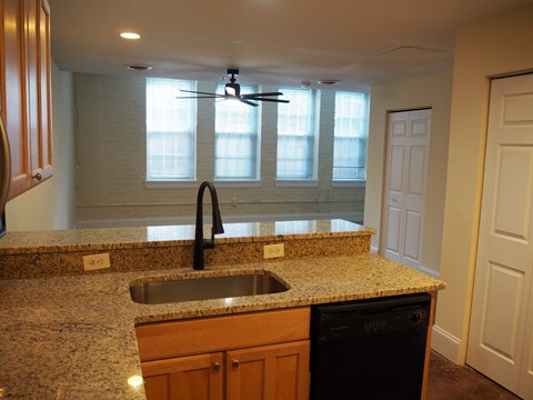 a kitchen with a granite counter top and a sink
