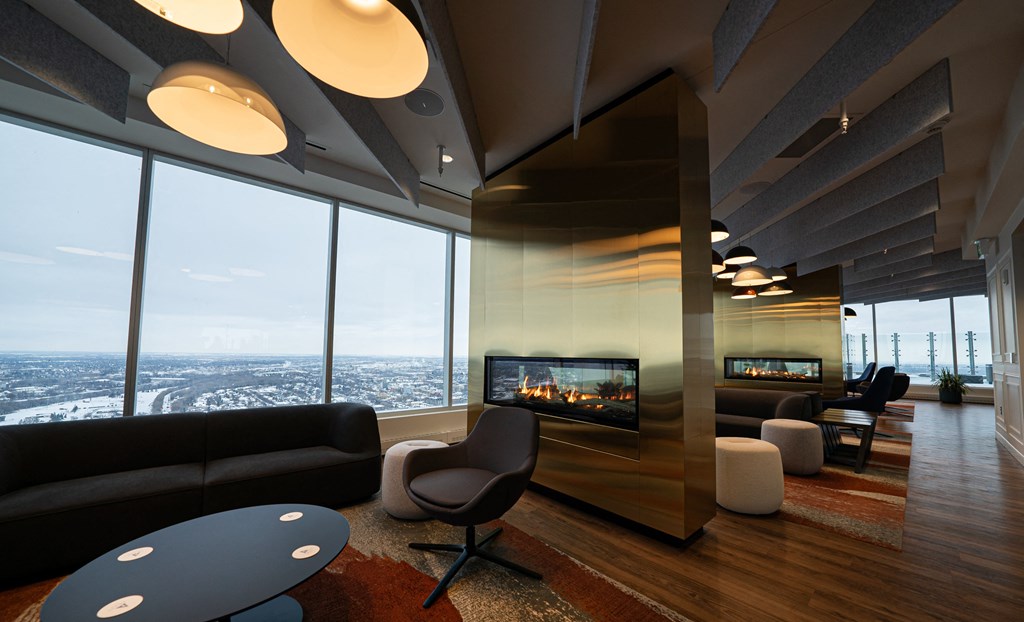a living room with a fireplace and a view of the city