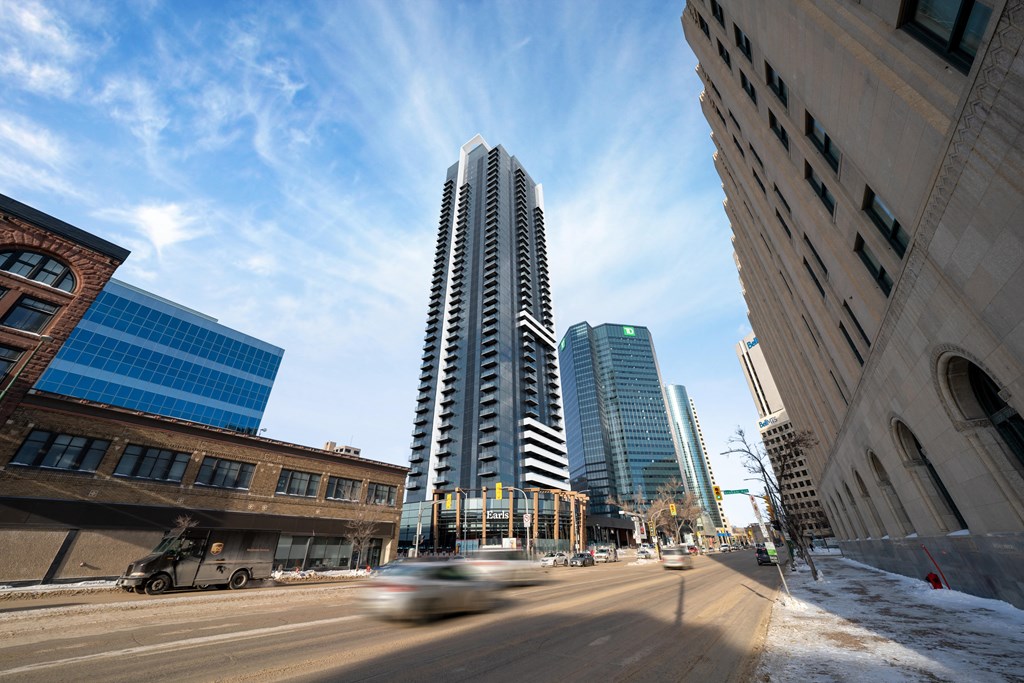 a view of a city street with cars and tall buildings