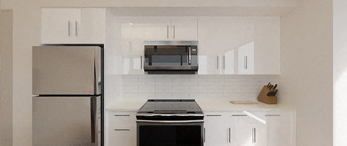 a white kitchen with stainless steel appliances and white cabinets