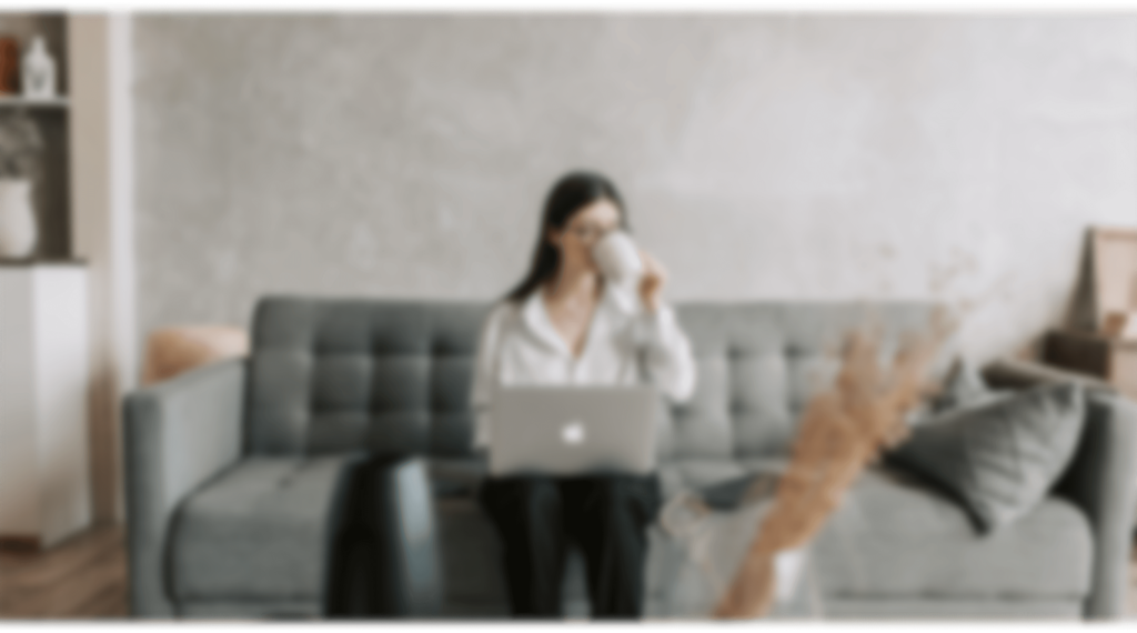 a woman sitting on a couch with a laptop