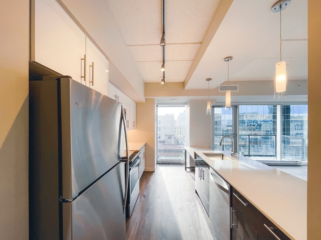 a large kitchen with stainless steel appliances and a large window