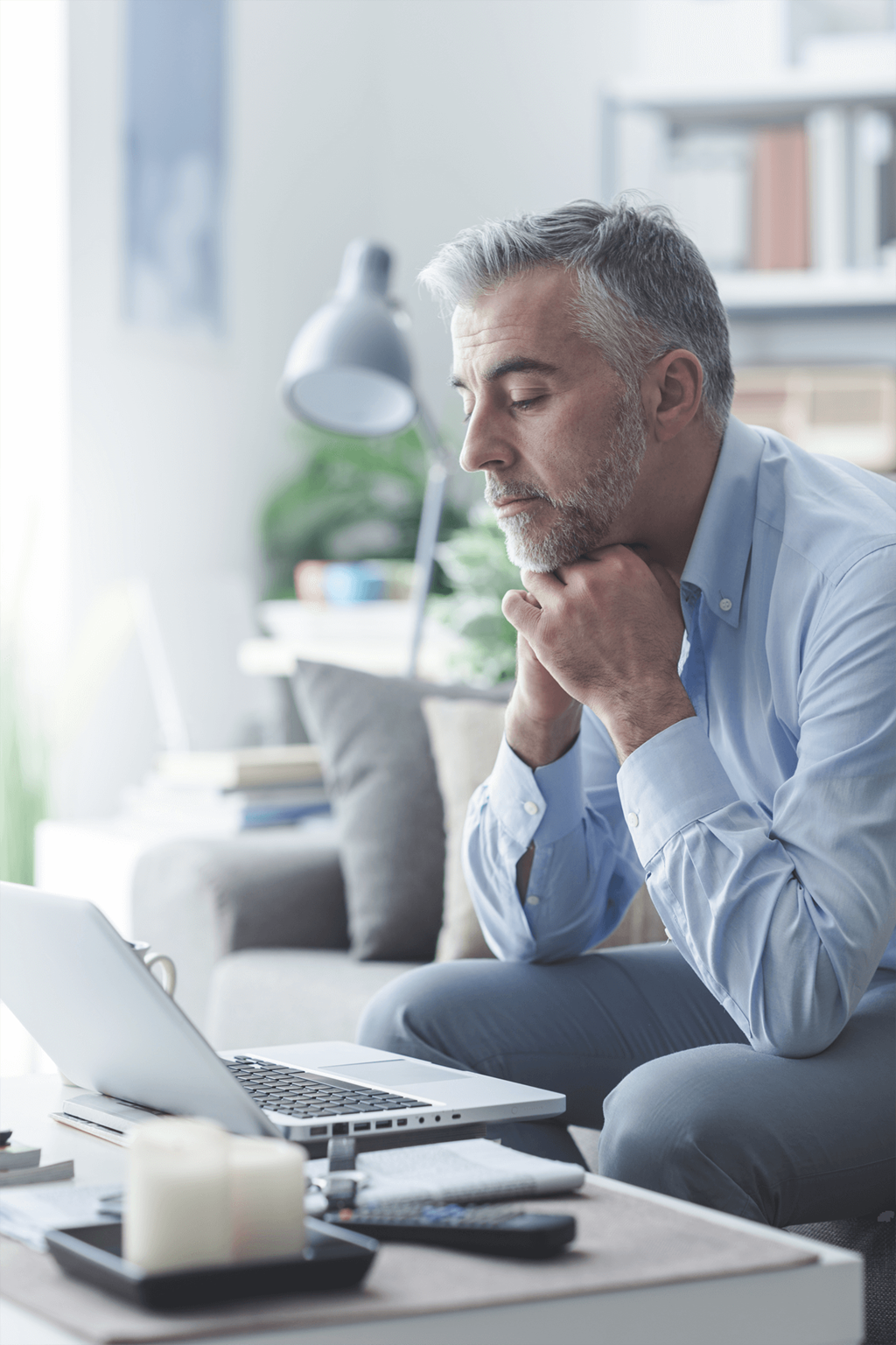 a man sitting in front of a laptop computer